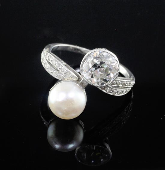 A platinum, cultured pearl and diamond set crossover ring with diamond set shoulders, size M.